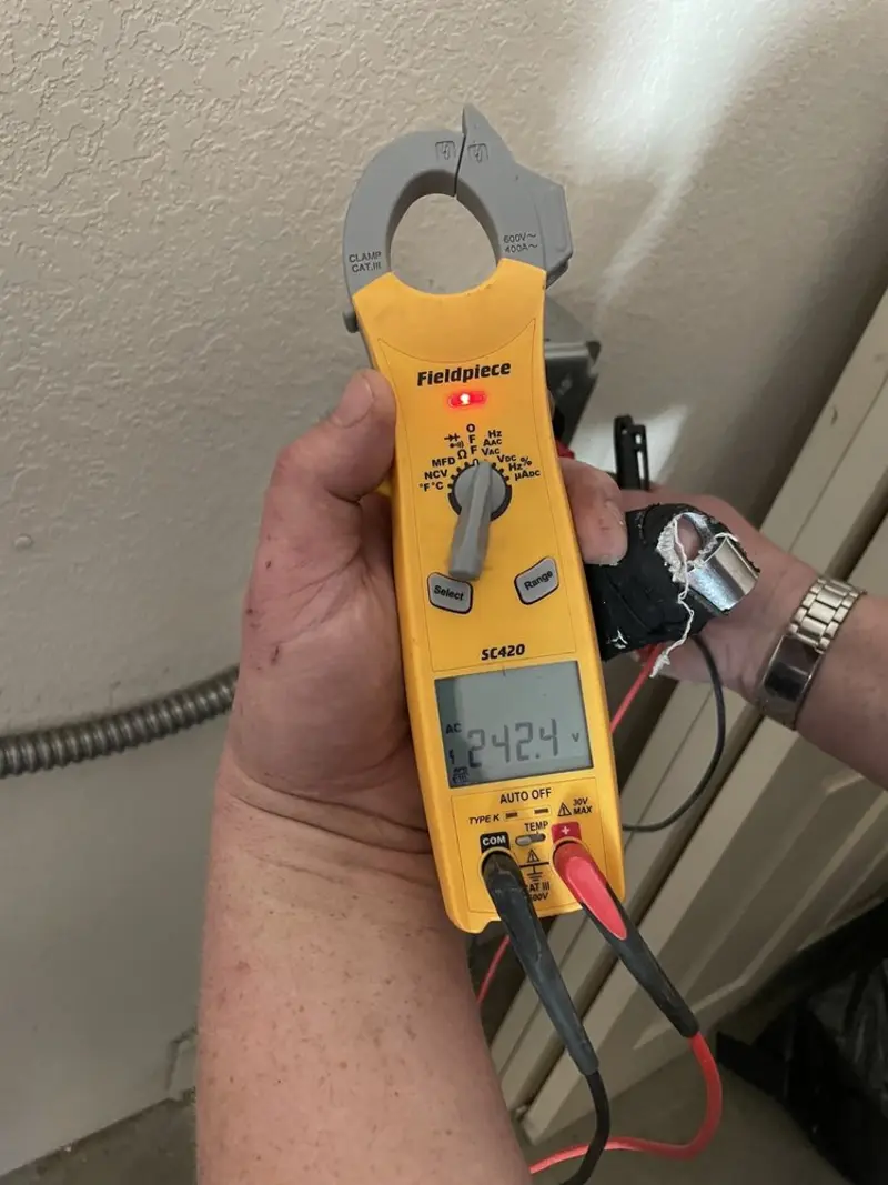 Voltage testing with clamp meter during Ceiling Fan Installation in Longboat Key